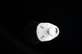 the bright white pressurized capsule of the spacex cargo dragon 