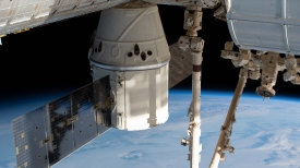 the spacex dragon cargo craft and station above the indian ocean