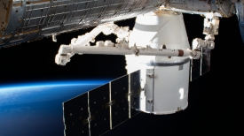 the spacex dragon cargo craft is attached to the space station