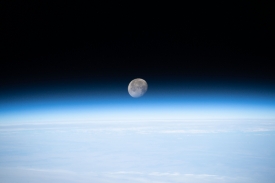 the waning gibbous moon above earths horizon