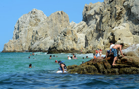 tourist swimming and snorkeling in cabo san lucas