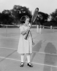 young girl holding a tennis racquet