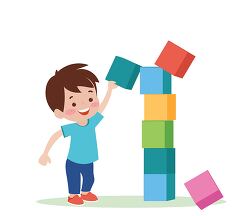 young boy knocking over a tower of colorful blocks