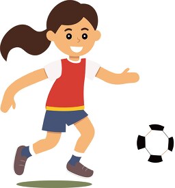 young girl determined to kick a soccer ball