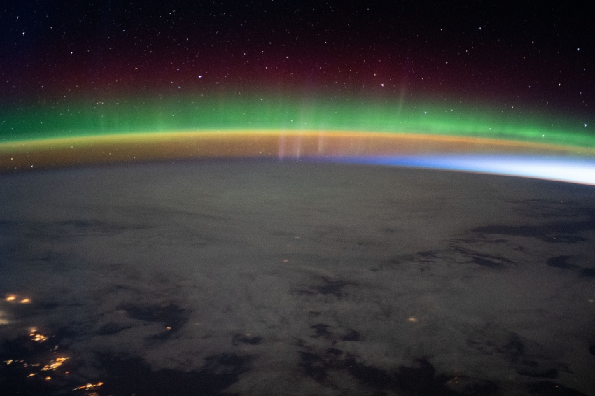 A bright aurora crowns Earth horizon