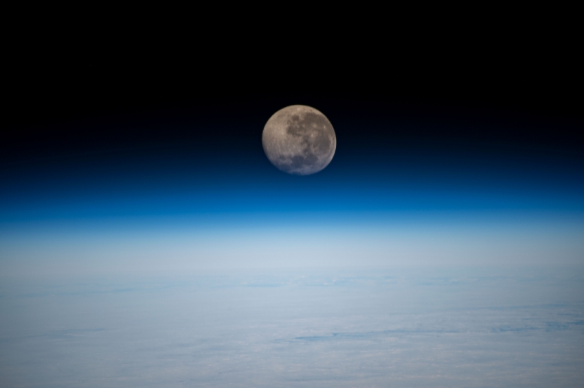a waning gibbous moon above the earths horizon 11