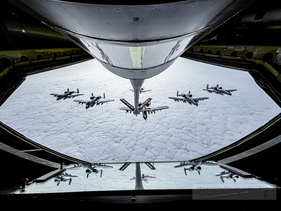 A-10 Thunderbolt II aircraft fly in formation behind a KC-135 St
