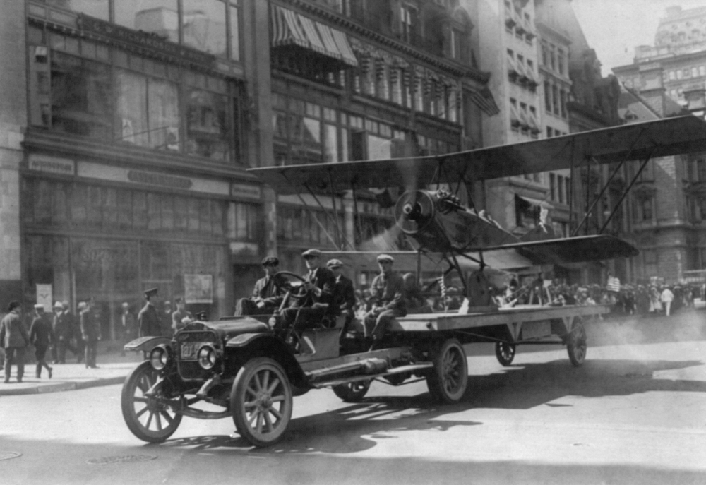 Airplane with engine running on a White in parade