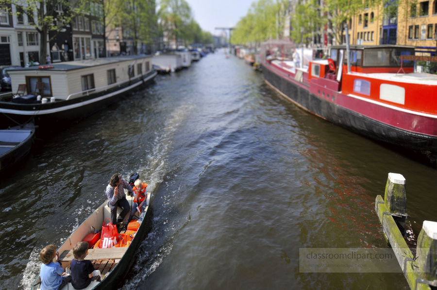 Amsterdams famous canals with a tourist boat during spring