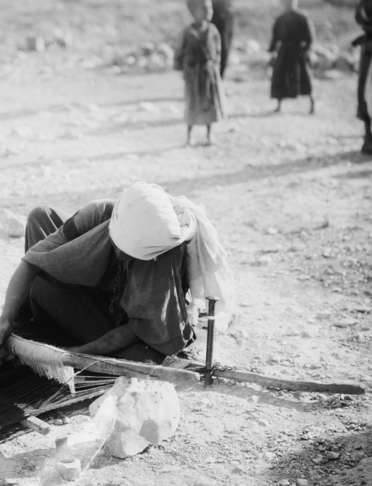 Arab-woman weaving on a loom