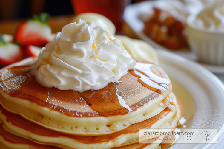 fluffy pancakes topped with a generous swirl of whipped cream