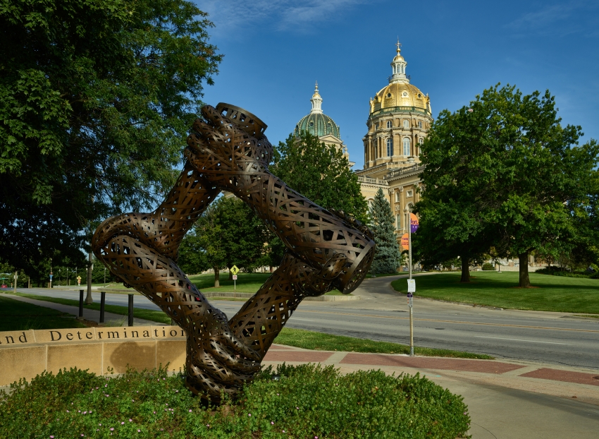 gilded dome of the Iowa capitol forms a backdrop for artist Mich