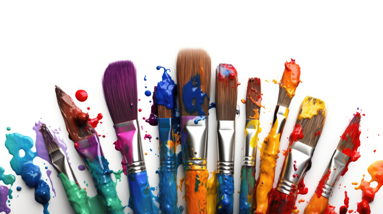 group of colorful paint filled paintbrushes resting on a white b