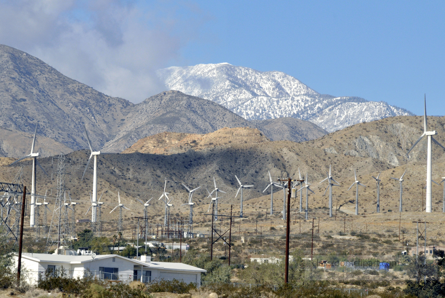 lightly snow covered mountains with windmills californa