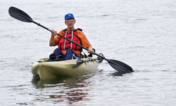 man kayaking on a calm lake wearing a life jacket and cap