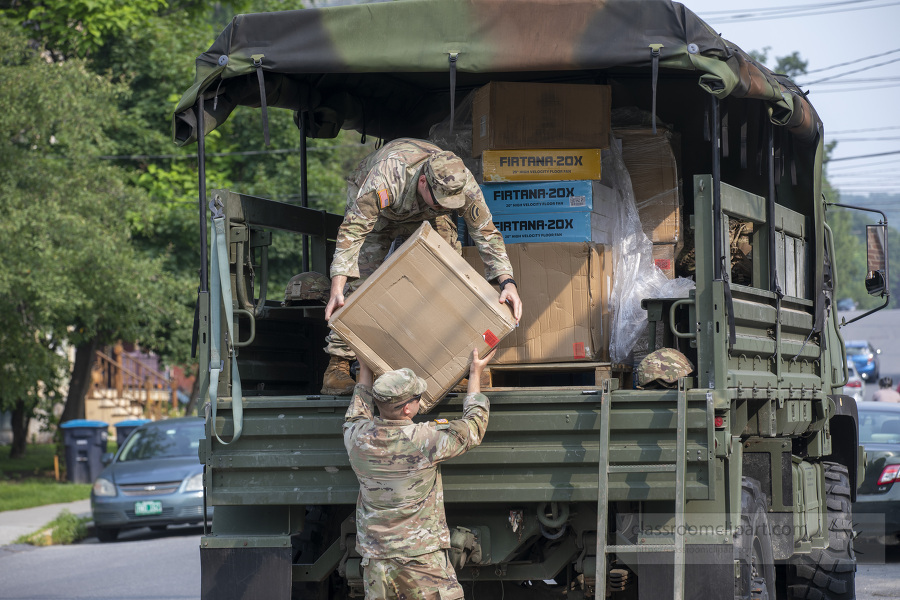 national guard removes supplies from a truc