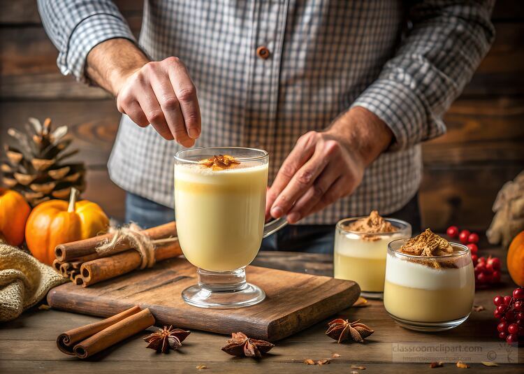 person garnishing a creamy fall drink with cinnamon