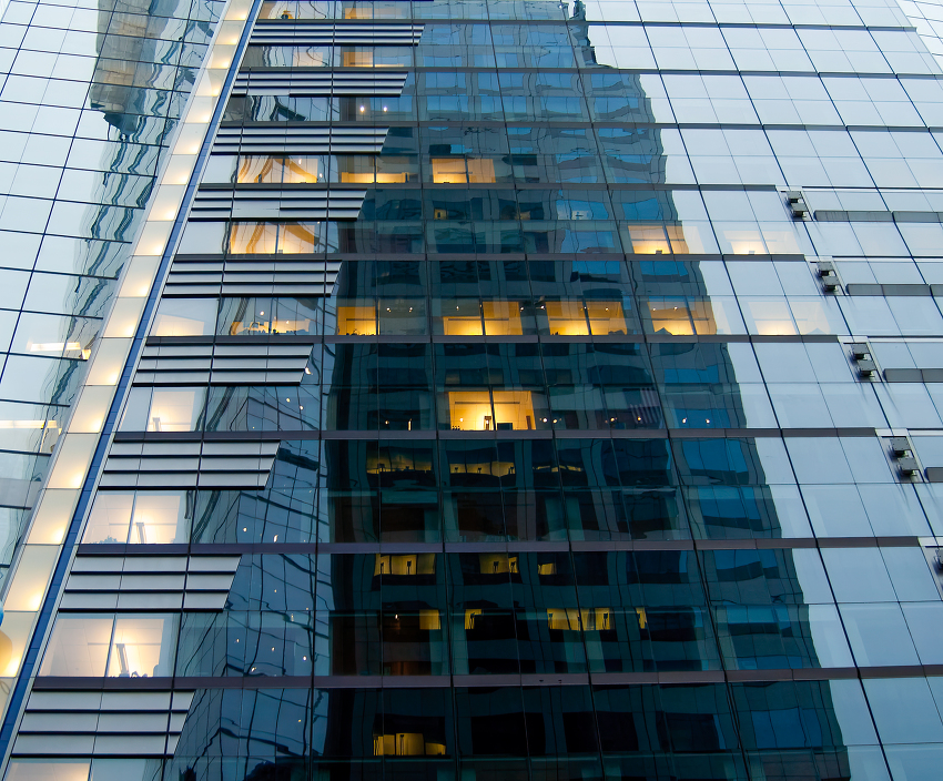 reflective facade of a modern building where the distorted refle