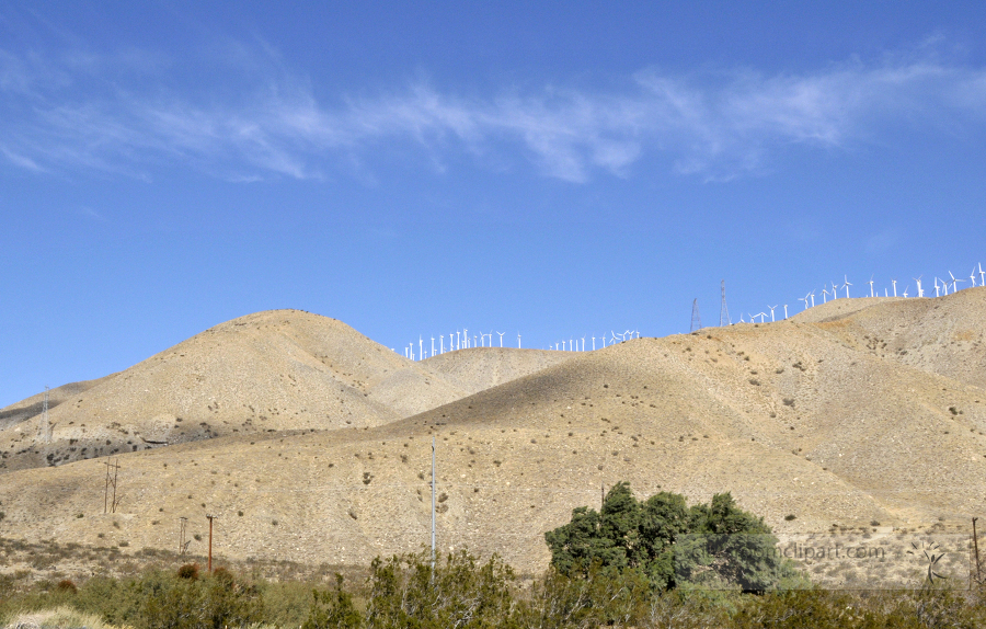 row of windmills along the top of hills near palm springs