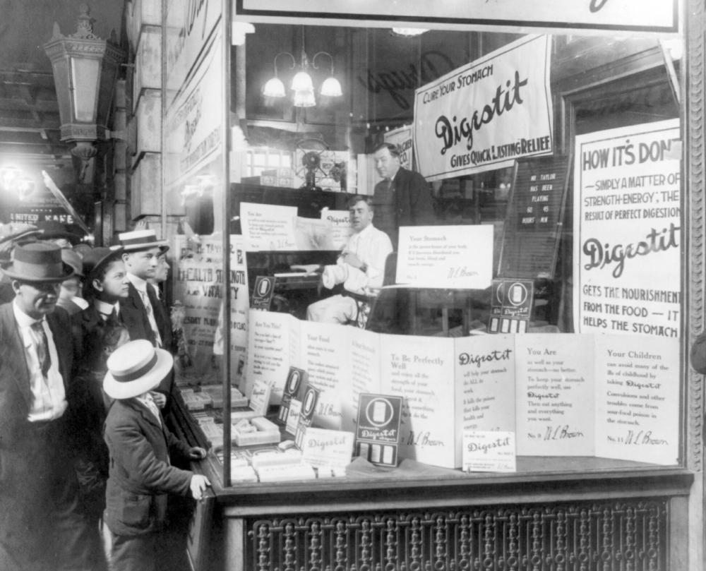 shoppers looking into a drug store 1915