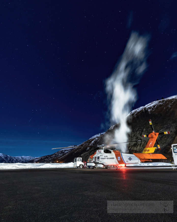 Sikorsky MH 60T Jayhawk helicopter in alaska with dark blue sky and stars in the backgorund