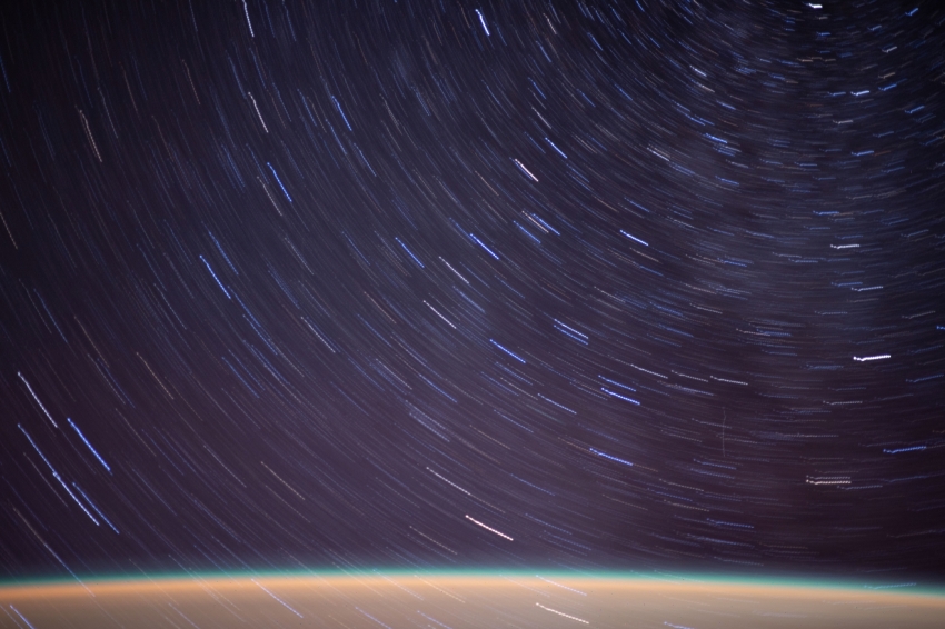 streaks of a starry field above earth