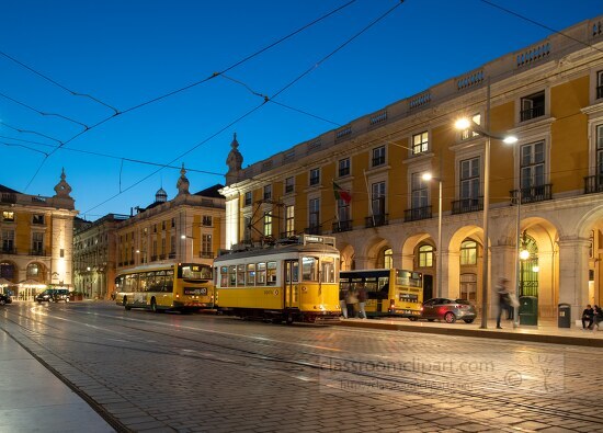 Trams on a street in Lisbon by night