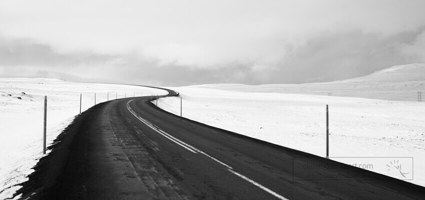windy road along snow mountains