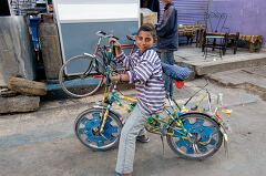 Boy Riding Colorful Bicycle in Aswan Egypt