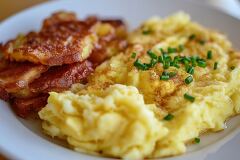 Delicious Breakfast With Eggs and Crispy Bacon Served Hot