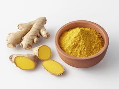 Fresh Ginger Roots and Ground Spice in a Rustic Bowl