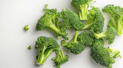 Lush Green Broccoli Arranged Elegantly on a White Surface