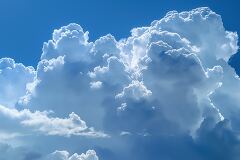 Majestic Cumulus Clouds Dominate the Bright Blue Sky