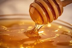 Mesmerizing Honey Drips From a Wooden Dipper Into a Jar