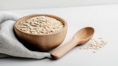 Rolled Oats in a Wooden Bowl With a Spoon Nearby