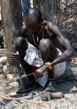 Samburu Man Engaged in Traditional Crafting in Kenya