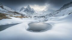 Snow capped Mountains and Serene Frozen Landscape in Winter