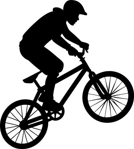 Silhouette of a BMX rider executing a jump with skill