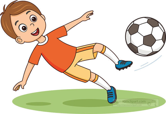 Smiling boy in an orange shirt kicking a soccer ball while leaning sideways above green grass