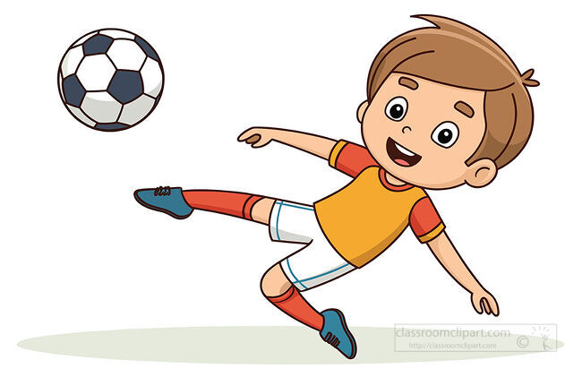 Smiling boy in an orange uniform performs a sideways soccer kick toward a ball above green ground