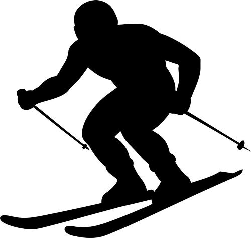 Silhouette of a skier gliding downhill with determination