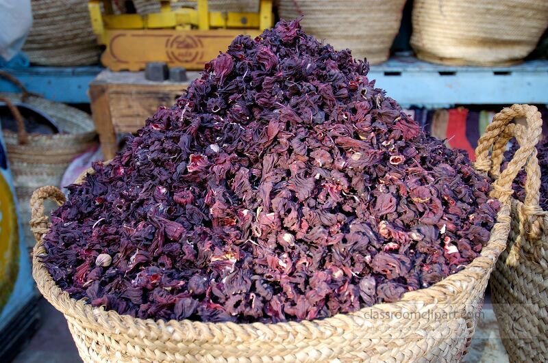 A vibrant pile of dried hibiscus flowers is showcased in a market in Aswan Egypt The flowers are rich in color and are a popular ingredient for beverages and teas