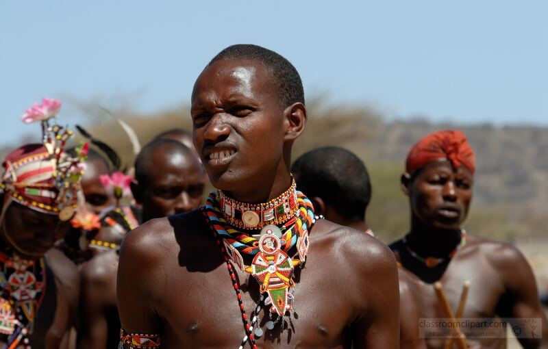 Members of the Samburu Tribe engage in traditional activities showcasing their vibrant attire and cultural heritage They gather in a desert landscape celebrating their customs and rich history amid the beauty of Kenyas wilderness