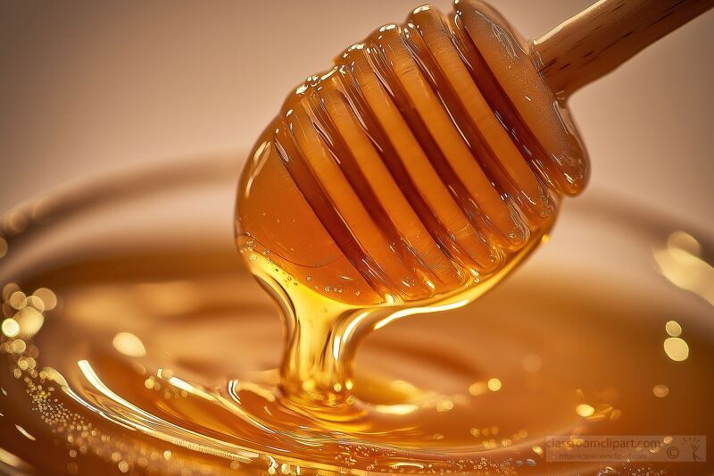 Golden Honey Cascades Gently Into a Glass Jar