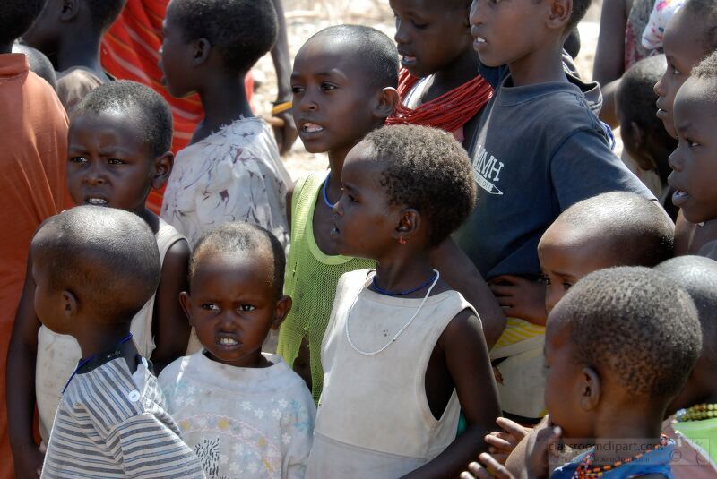 Children from the Samburu tribe of Kenya stand together in their village displaying a range of expressions and clothing styles Their community setting reflects their rich culture and traditions