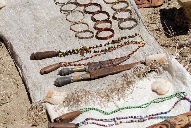 Handcrafted jewelry and traditional items from the Samburu Tribe of Kenya are arranged on fabric under the sun Colorful beads bracelets and unique artifacts showcase the rich cultural heritage and craftsmanship of the Samburu artisans