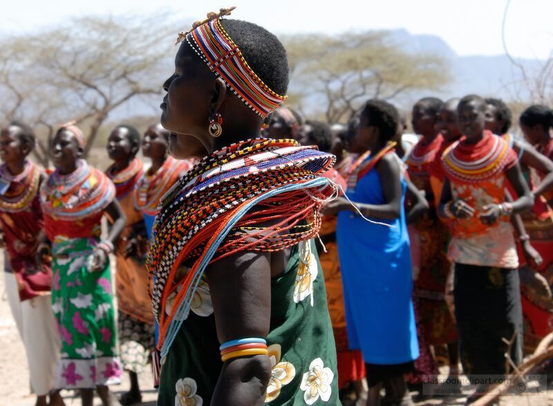 Women from the Samburu tribe in Kenya engage in a vibrant dance showcasing their traditional attire and jewelry The community gathers together filled with joy and cultural pride under the clear sky