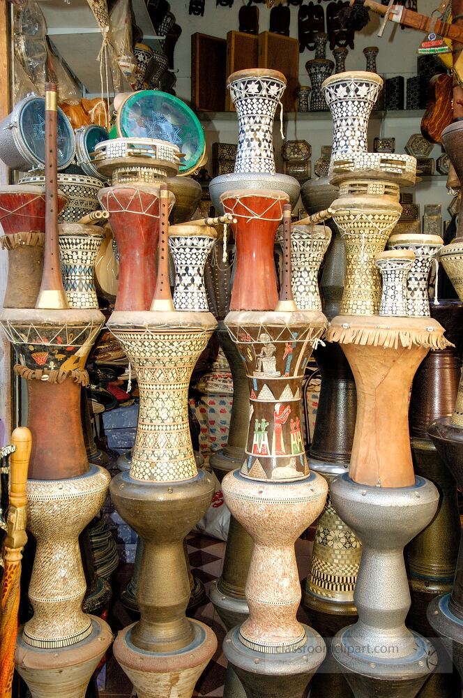 Colorful traditional pottery and drums are displayed for sale in a market in Aswan Egypt The intricate designs showcase local craftsmanship and cultural heritage