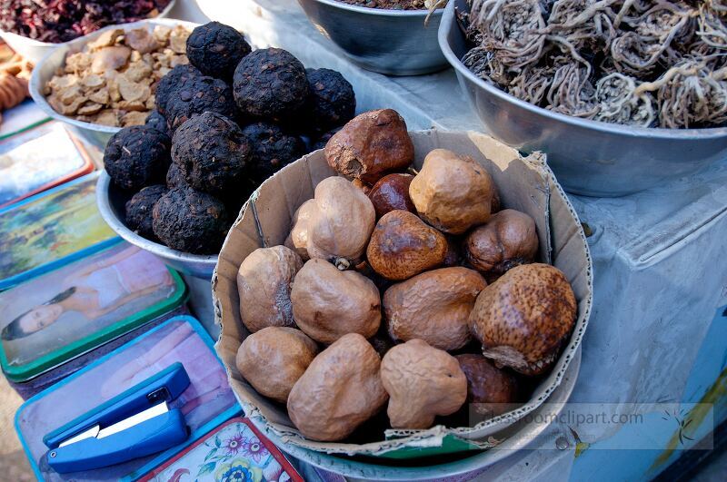 A vibrant market stall in Aswan Egypt showcases a variety of dried herbs and spices Unusual shapes and colors attract passersby highlighting local flavors and culinary traditions