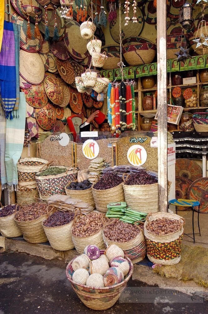 Colorful baskets filled with spices textiles and crafts create a lively atmosphere in an Aswan market capturing the essence of Egyptian culture and trade